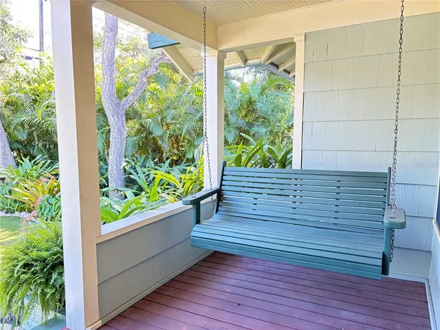 a view of balcony with wooden floor and outdoor seating