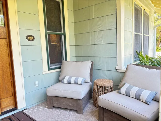 a view of a patio with table and chairs with wooden fence and plants