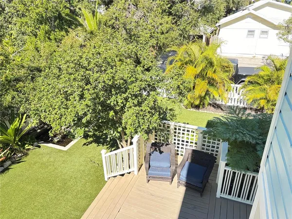 a view of balcony with wooden floor and outdoor seating