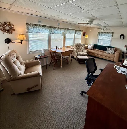 a view of a livingroom with workspace and a window