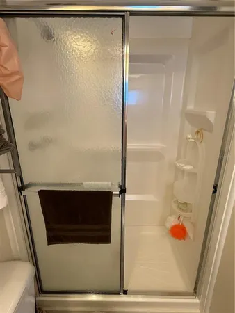 a bathroom with a shower and a sink
