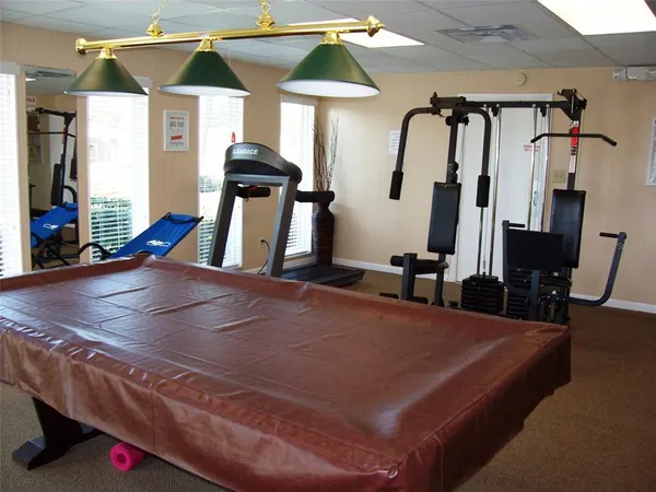 a room with gym equipment and a mirror