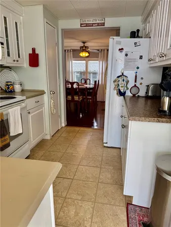 a kitchen with granite countertop a sink and cabinets