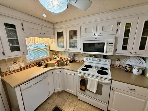 a kitchen with stainless steel appliances a stove sink and cabinets