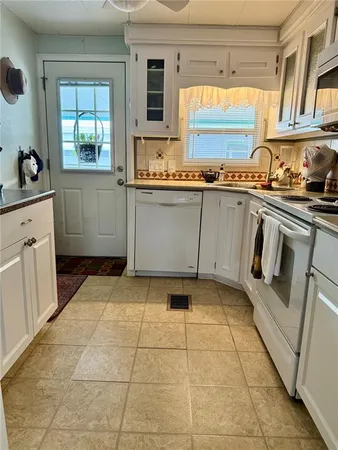 a kitchen with a stove a sink and a refrigerator