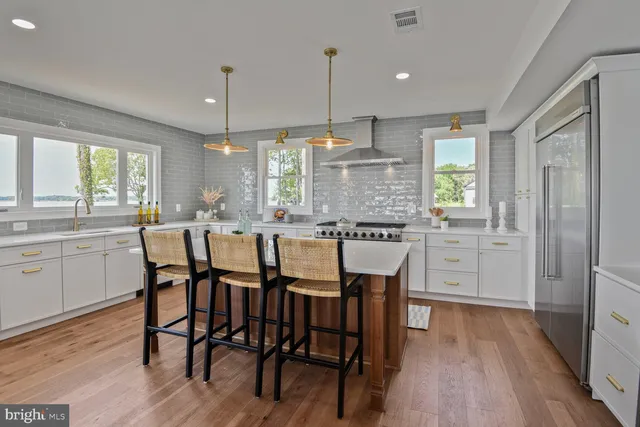 a view of a dining room with furniture wooden floor and a chandelier