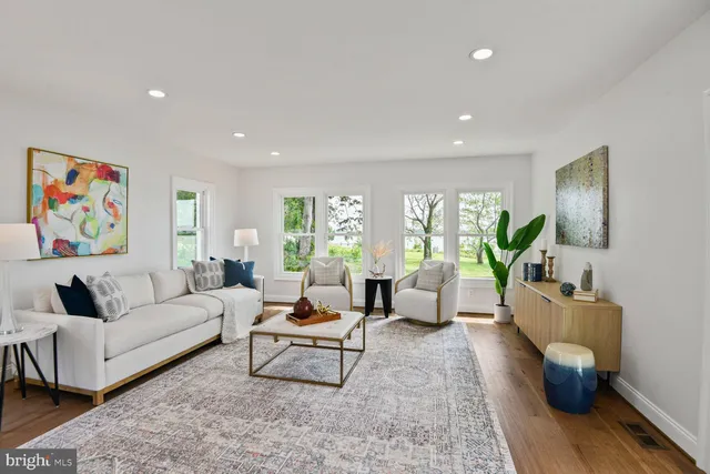a view of a dining room with furniture wooden floor and a chandelier