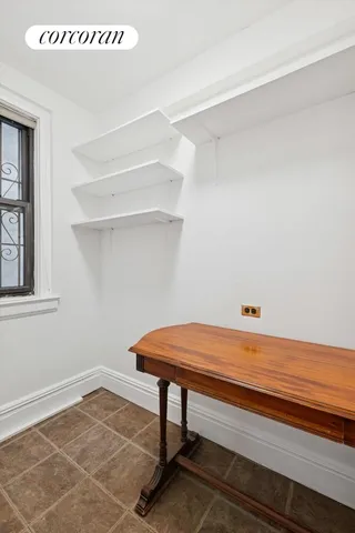 a room that has a window and a table in it