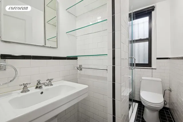 a bedroom with a large bed and a flat tv screen on dresser