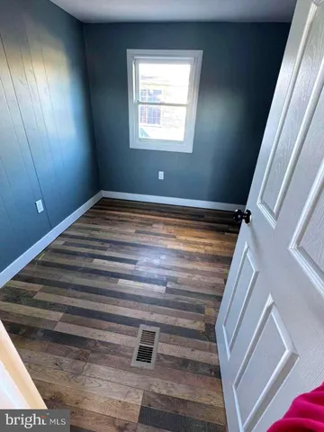 a view of a room with wooden floor and staircase