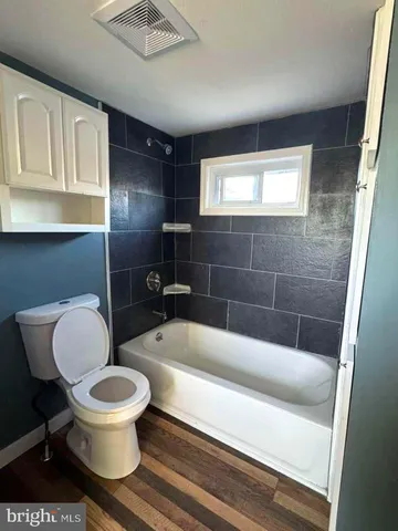 a bathroom with a toilet a sink and bathtub