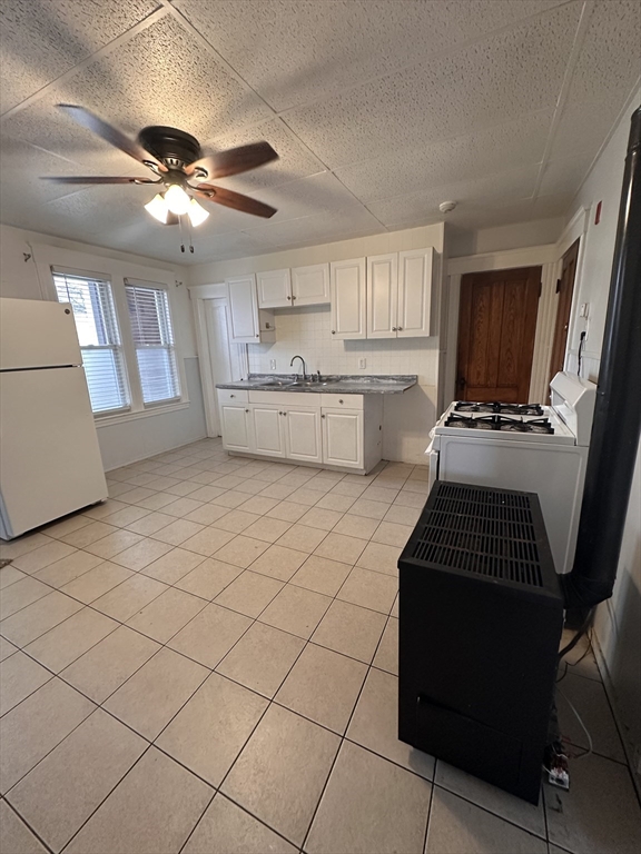 a kitchen with a stove a sink and a refrigerator