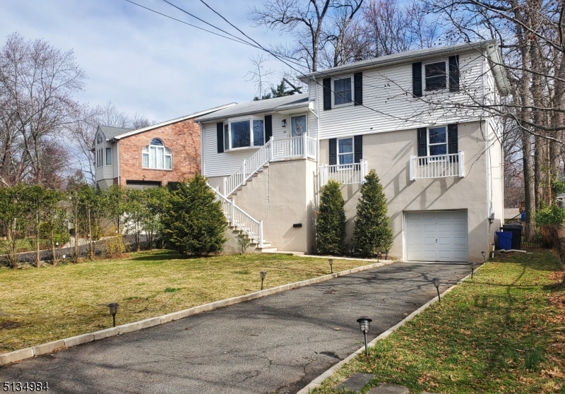 512 Riverside Drive Cranford, NJ 07016 - Photo 1 of 22 a front view of a house with a yard and garage
