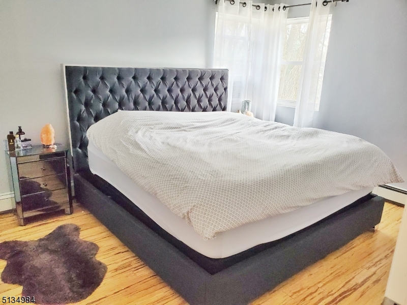 512 Riverside Drive Cranford, NJ 07016 - Photo 14 of 22 a bed sitting in a bedroom next to a window