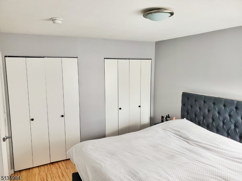 512 Riverside Drive Cranford, NJ 07016 - Photo 15 of 22 a bedroom with a bed and wooden floor