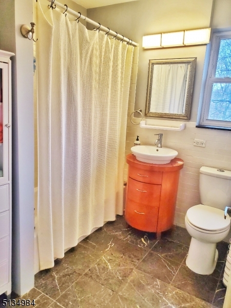 512 Riverside Drive Cranford, NJ 07016 - Photo 16 of 22 a bathroom with a toilet a sink and a mirror