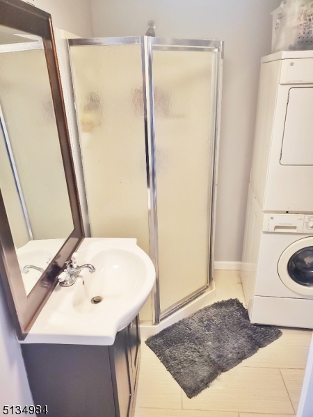 512 Riverside Drive Cranford, NJ 07016 - Photo 22 of 22 a bathroom with a sink a mirror and a shower