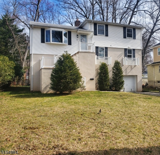 512 Riverside Drive Cranford, NJ 07016 - Photo 4 of 22 a front view of a house with a yard