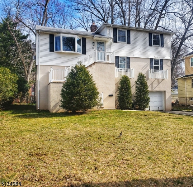 512 Riverside Drive Cranford, NJ 07016 - Photo 5 of 22 a front view of a house with a garden
