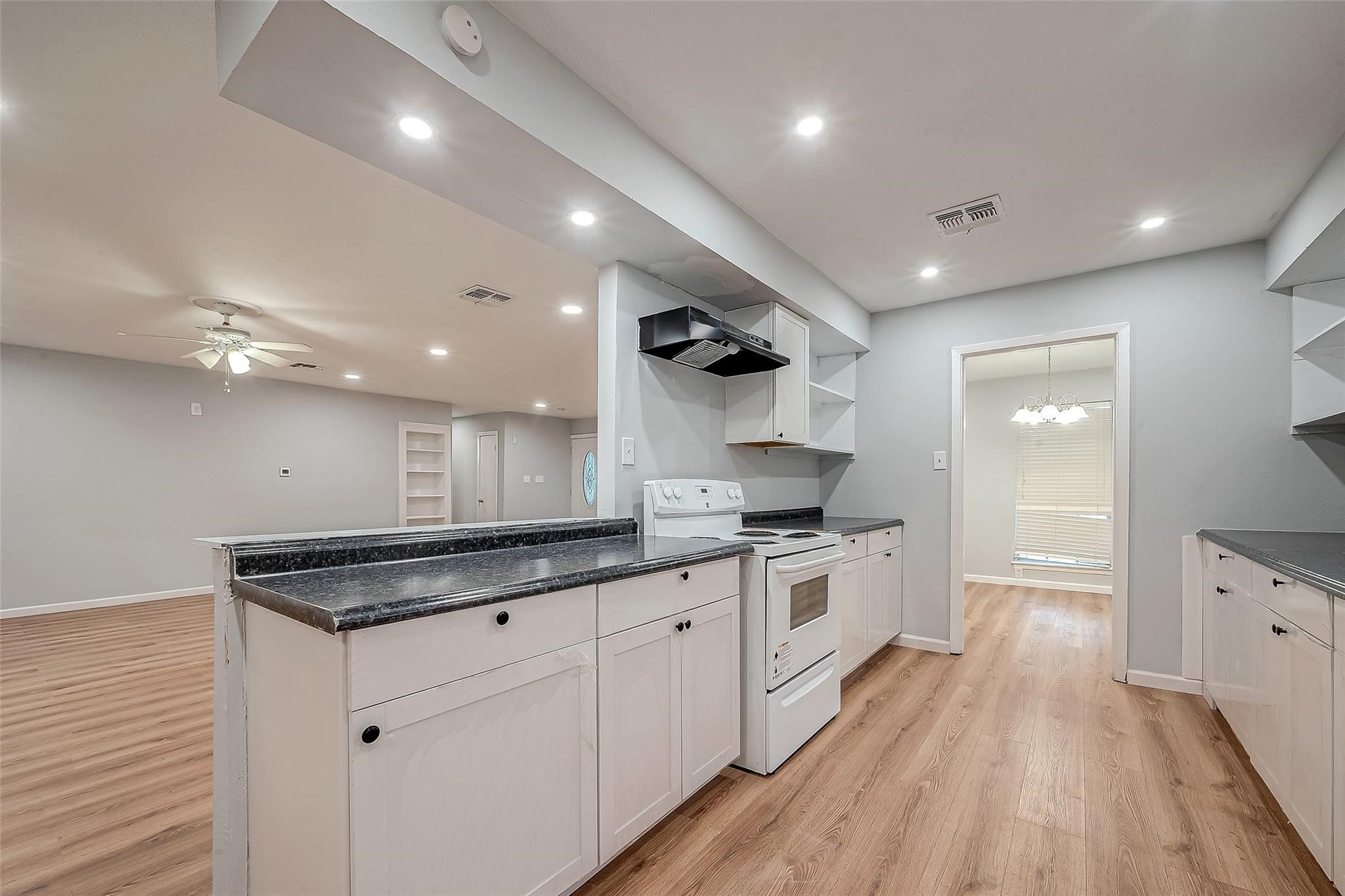 23131 Earlmist Drive Spring, TX 77373 - Photo 12 of 34 a large kitchen with stainless steel appliances granite countertop a lot of counter space and wooden floors