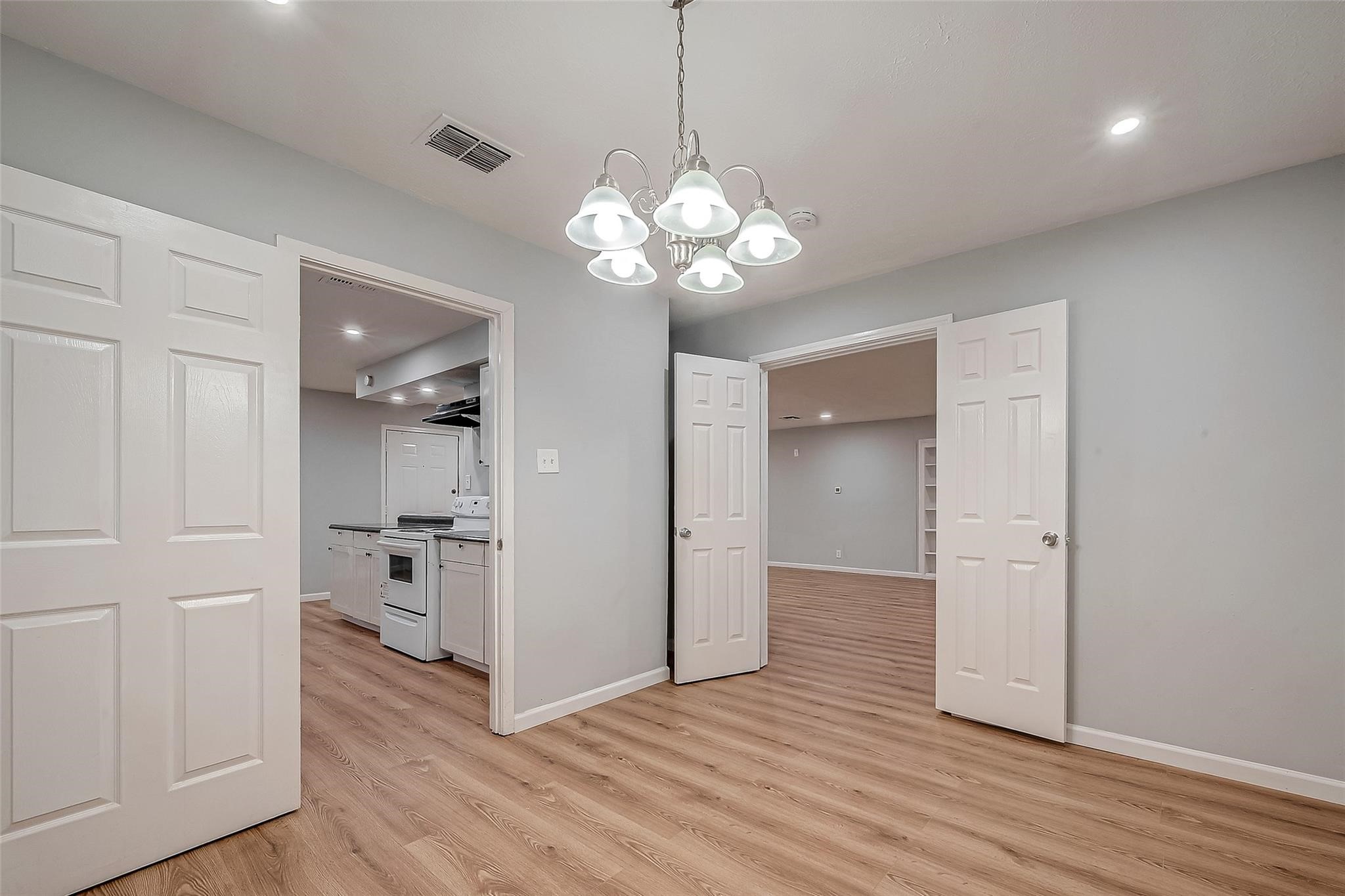 23131 Earlmist Drive Spring, TX 77373 - Photo 19 of 34 a view of a hallway with wooden floor and a chandelier