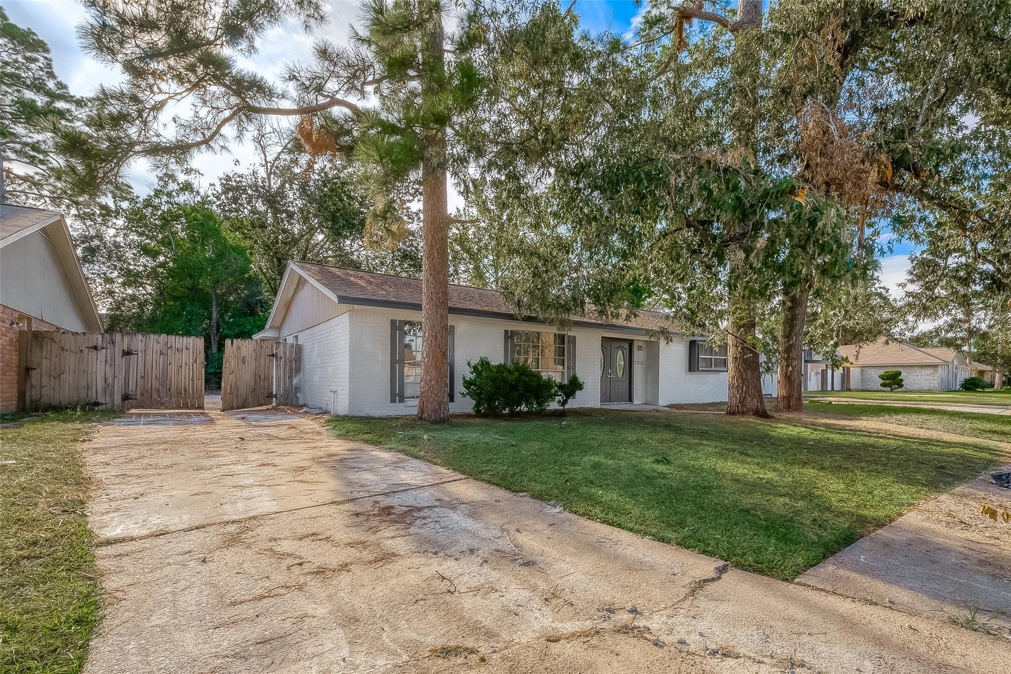 23131 Earlmist Drive Spring, TX 77373 - Photo 2 of 34 a front view of a house with a yard and trees