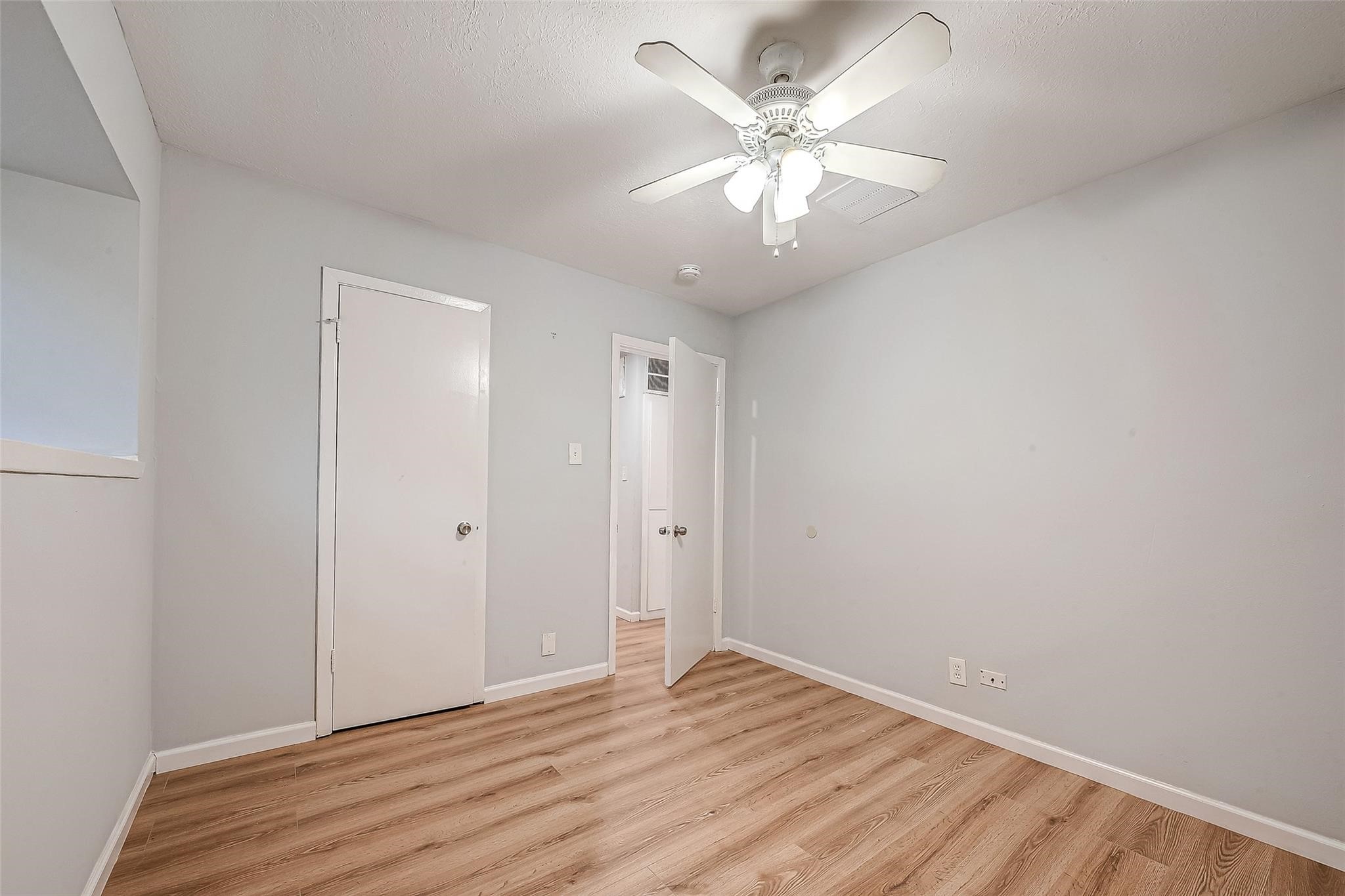 23131 Earlmist Drive Spring, TX 77373 - Photo 22 of 34 an empty room with wooden floor and ceiling fan