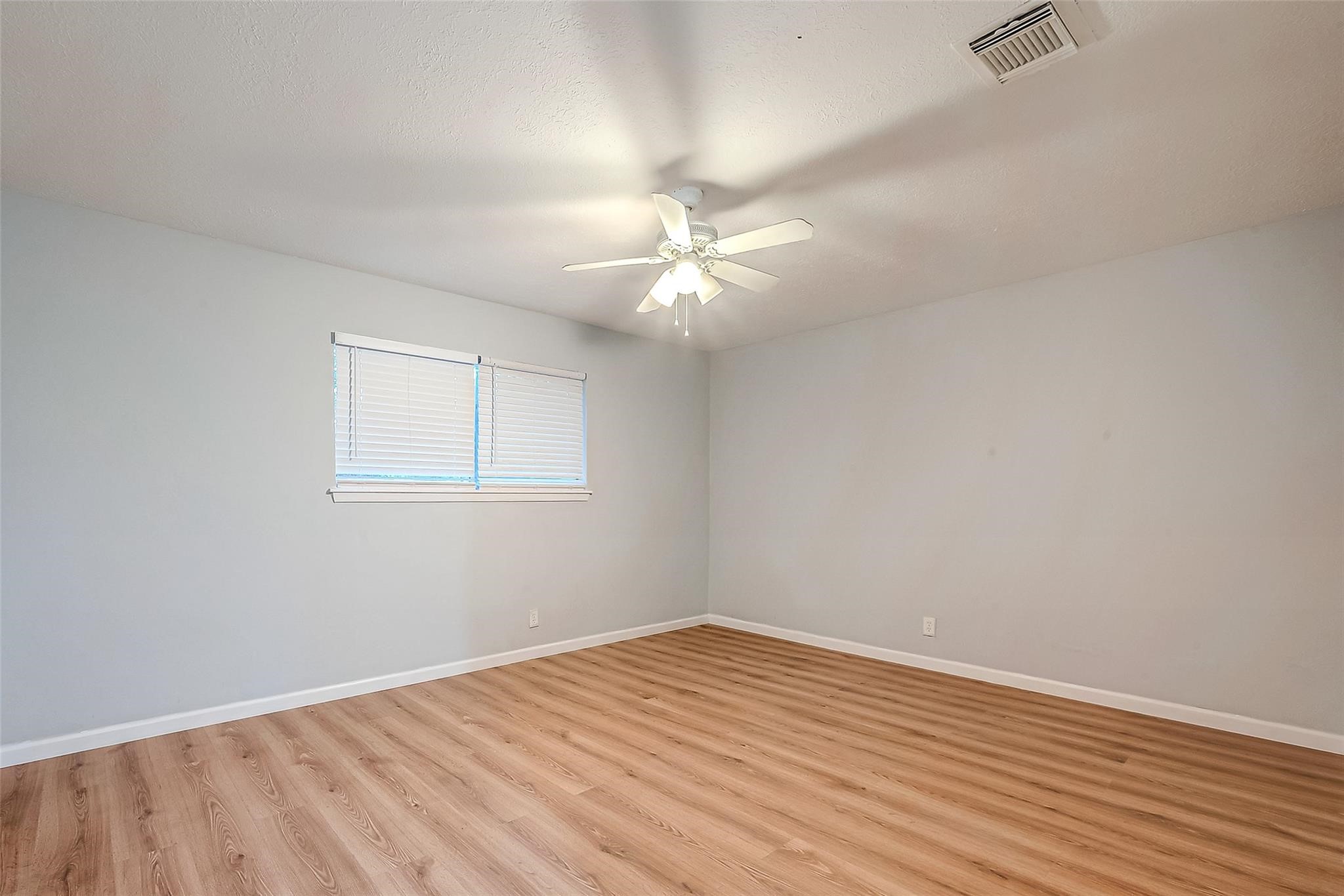 23131 Earlmist Drive Spring, TX 77373 - Photo 26 of 34 a view of a room with wooden floor and a ceiling fan