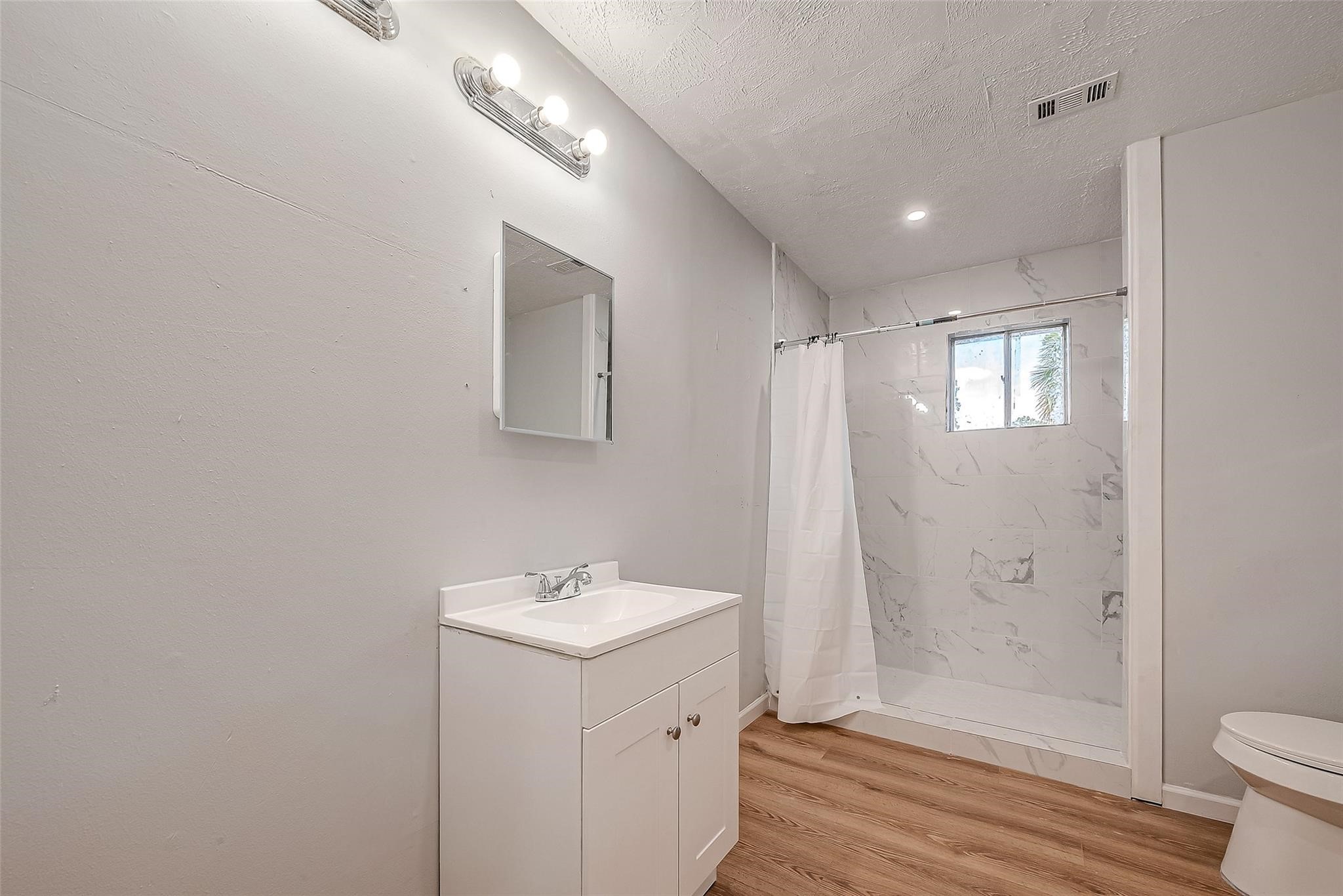 23131 Earlmist Drive Spring, TX 77373 - Photo 28 of 34 a bathroom with a sink a toilet and shower
