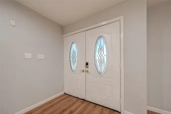 a view of a hallway with wooden floor