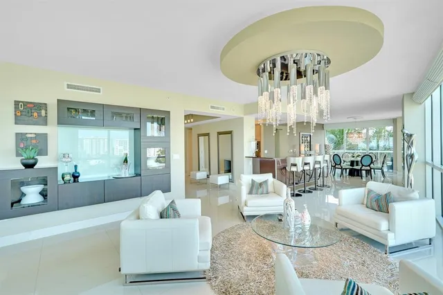 a dining room with furniture a chandelier and window