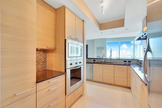 a spacious bedroom with a bed and glass window