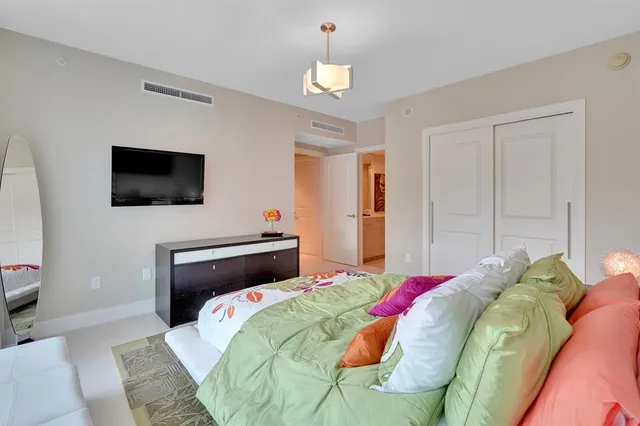 a bathroom with a sink a toilet a mirror and shower