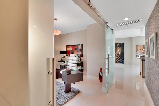 a view of a patio with a table and chairs and potted plants