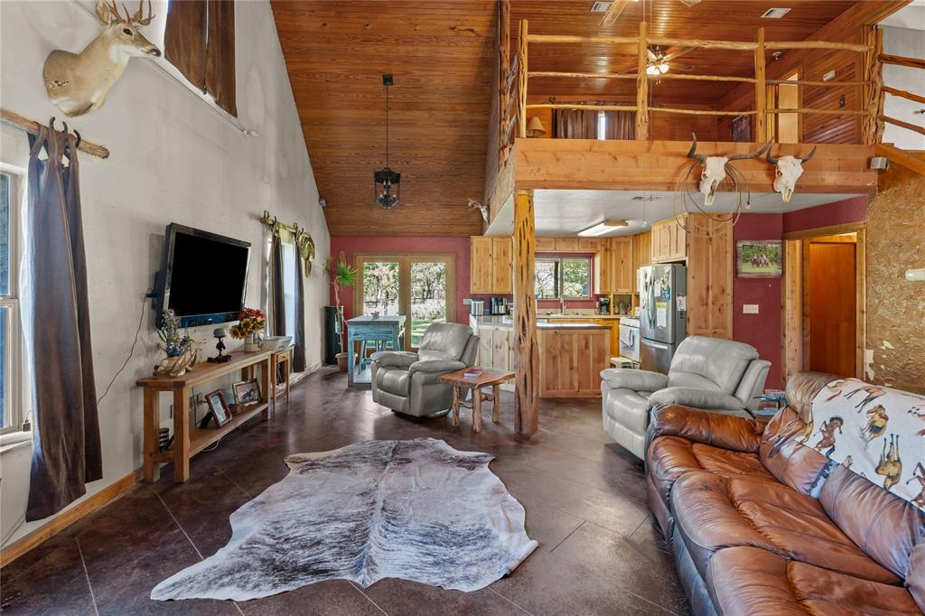 262 North Cheyenne Springtown, TX 76082 - Photo 11 of 35 Living area with high vaulted ceiling, wood ceiling, and a ceiling fan