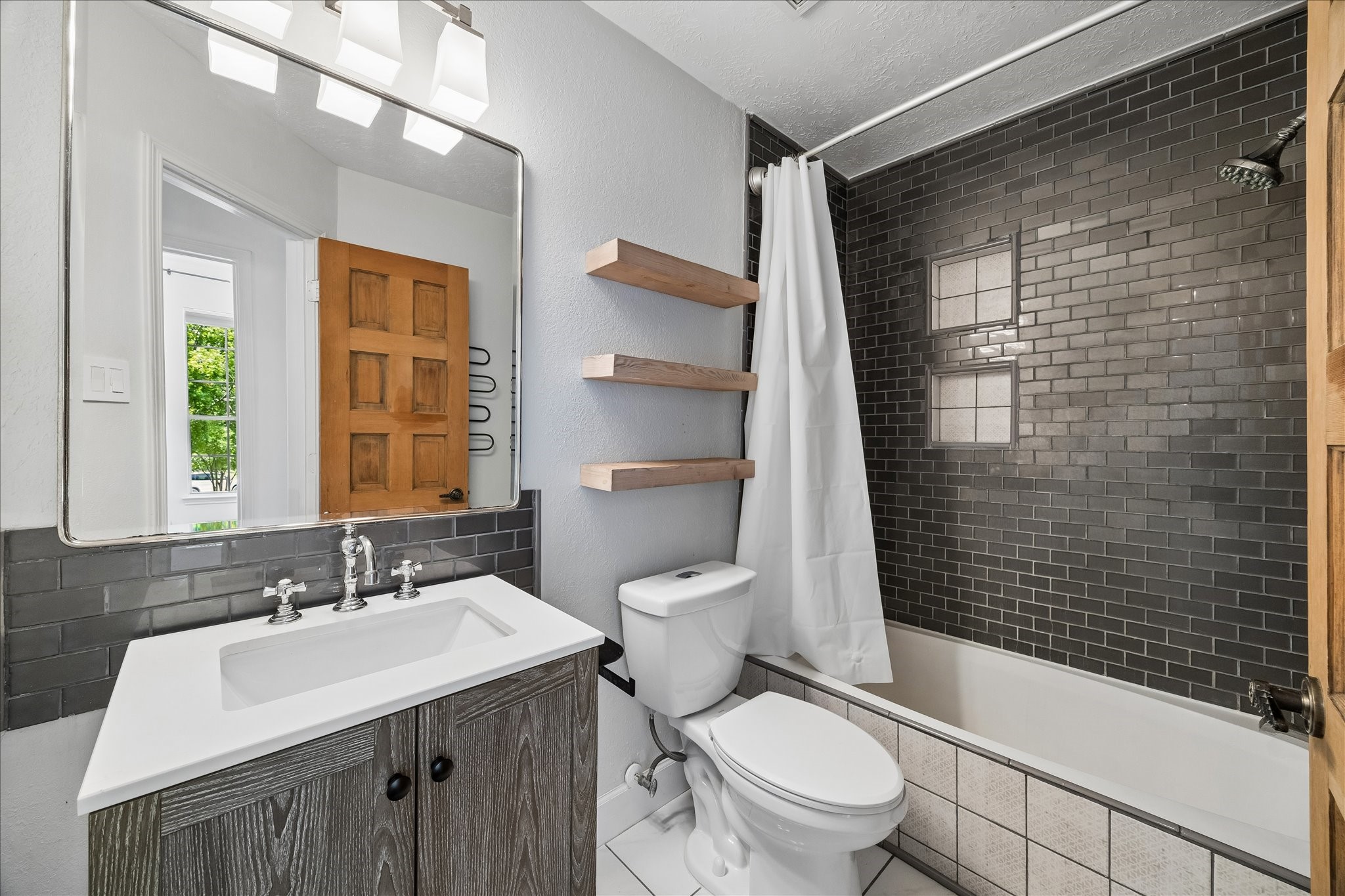 7919 Clarion Way Houston, TX 77040 - Photo 17 of 23 Updated secondary bathroom with convenient hallway access to the secondary bedrooms and game room.