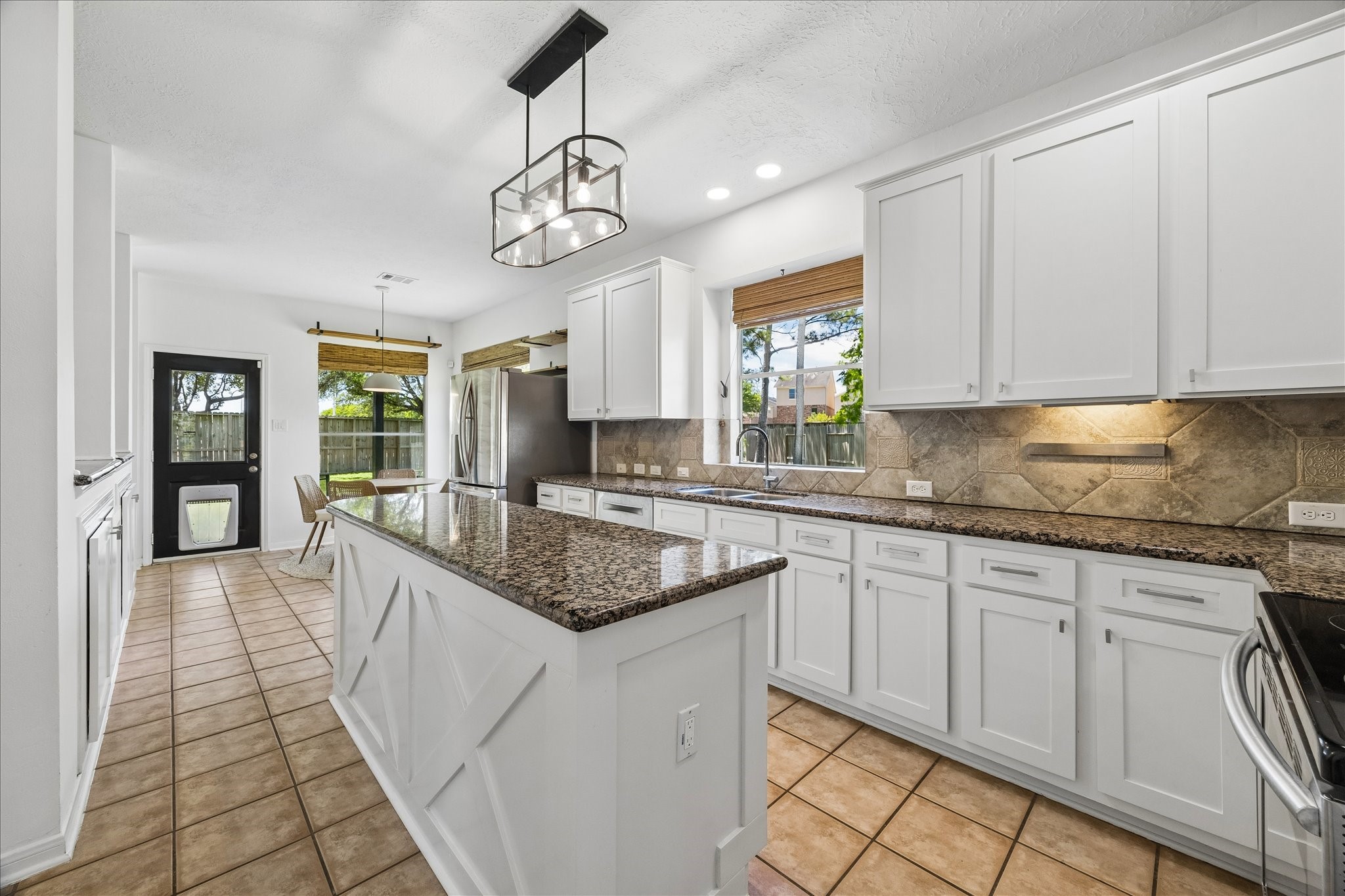 7919 Clarion Way Houston, TX 77040 - Photo 8 of 23 The kitchen features ample cabinetry, granite counters, and stainless steel appliances.