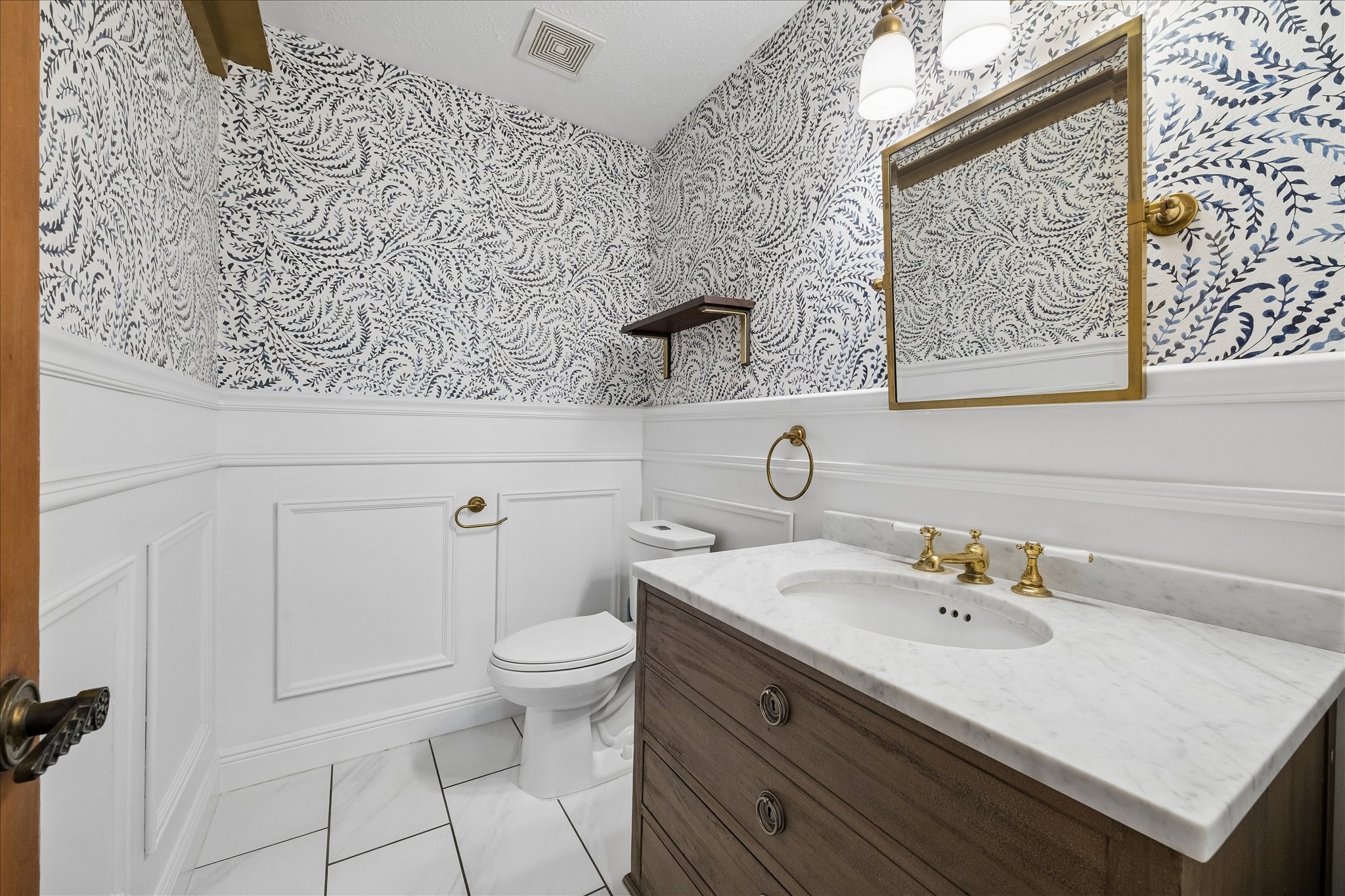 7919 Clarion Way Houston, TX 77040 - Photo 10 of 23 The updated half bath is conveniently located just off the family room.