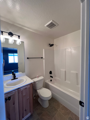 1696 South Longview Road Santaquin, UT 84655 - Photo 12 of 16 Full bathroom with vanity, shower / washtub combination, and a textured ceiling