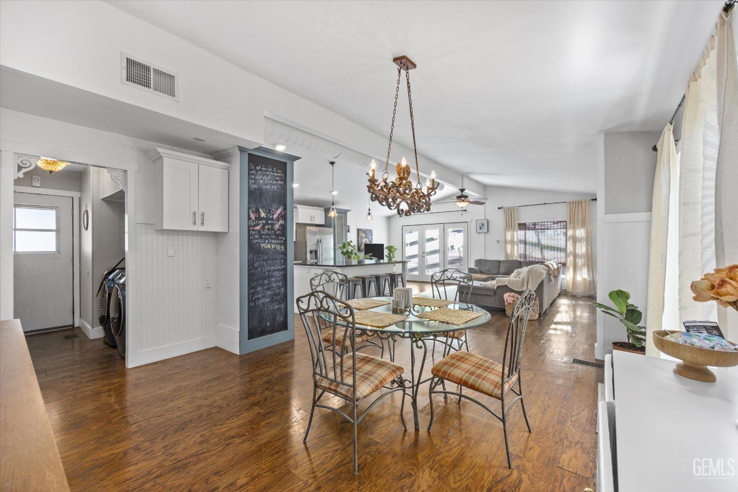 Undisclosed Address Bakersfield, CA 93306 - Photo 14 of 39 a view of a dining room and livingroom with furniture wooden floor a chandelier
