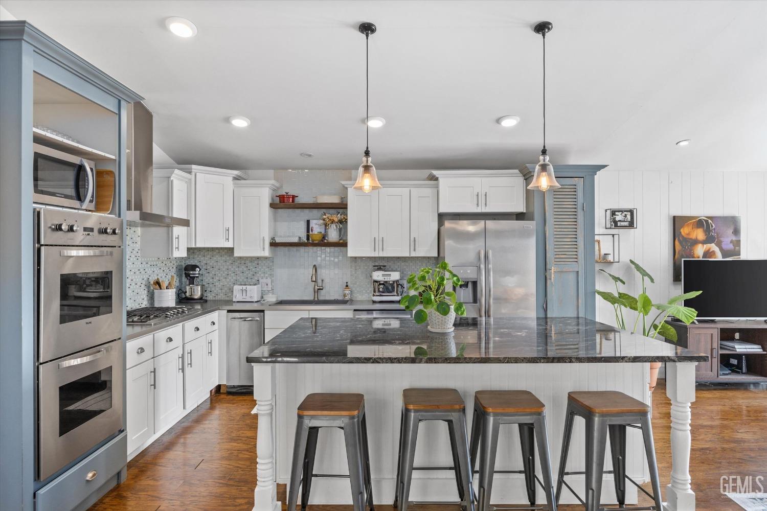 Undisclosed Address Bakersfield, CA 93306 - Photo 19 of 39 a kitchen with stainless steel appliances granite countertop a stove a sink and a refrigerator