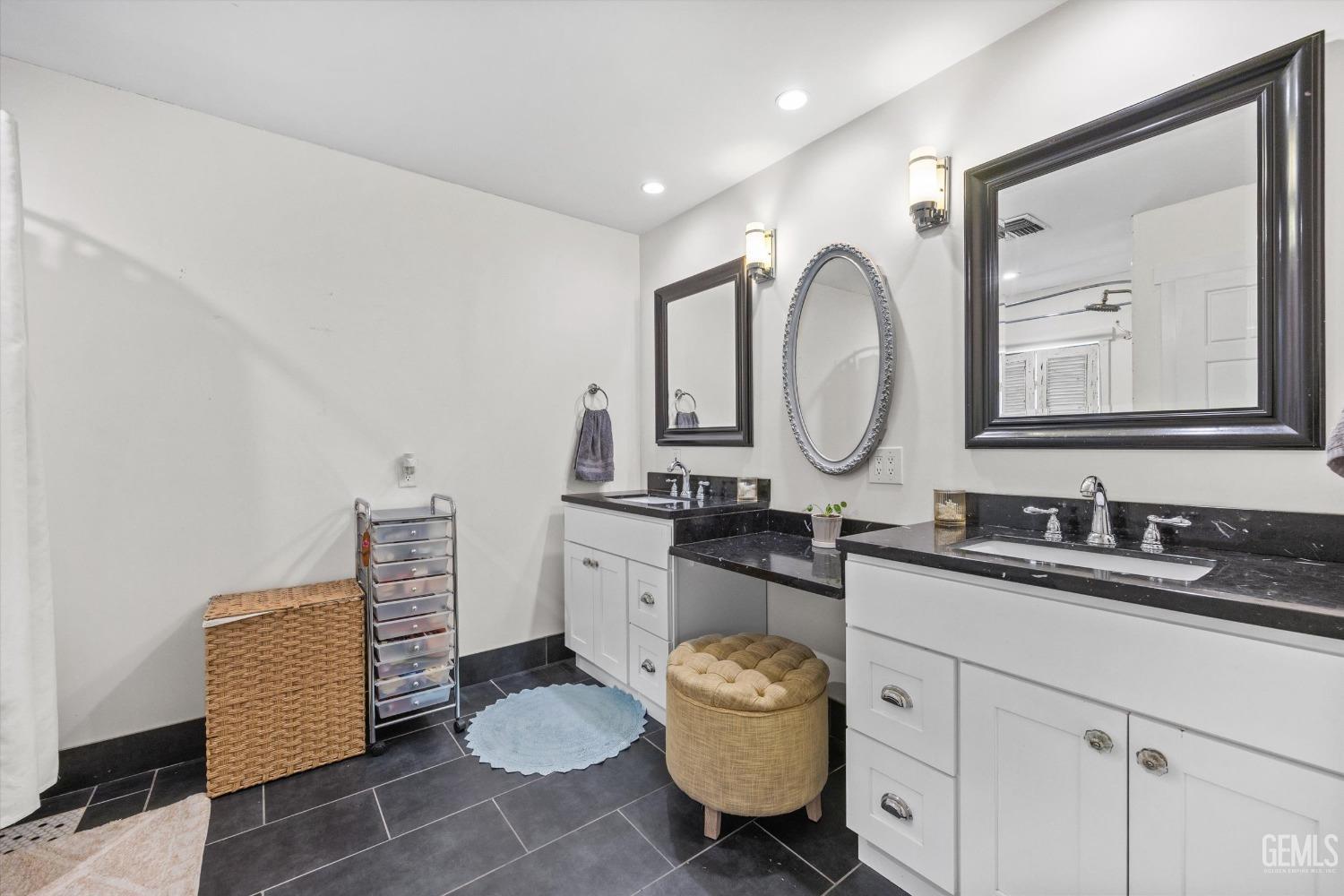Undisclosed Address Bakersfield, CA 93306 - Photo 23 of 39 a bathroom with a granite countertop sink mirror and toilet