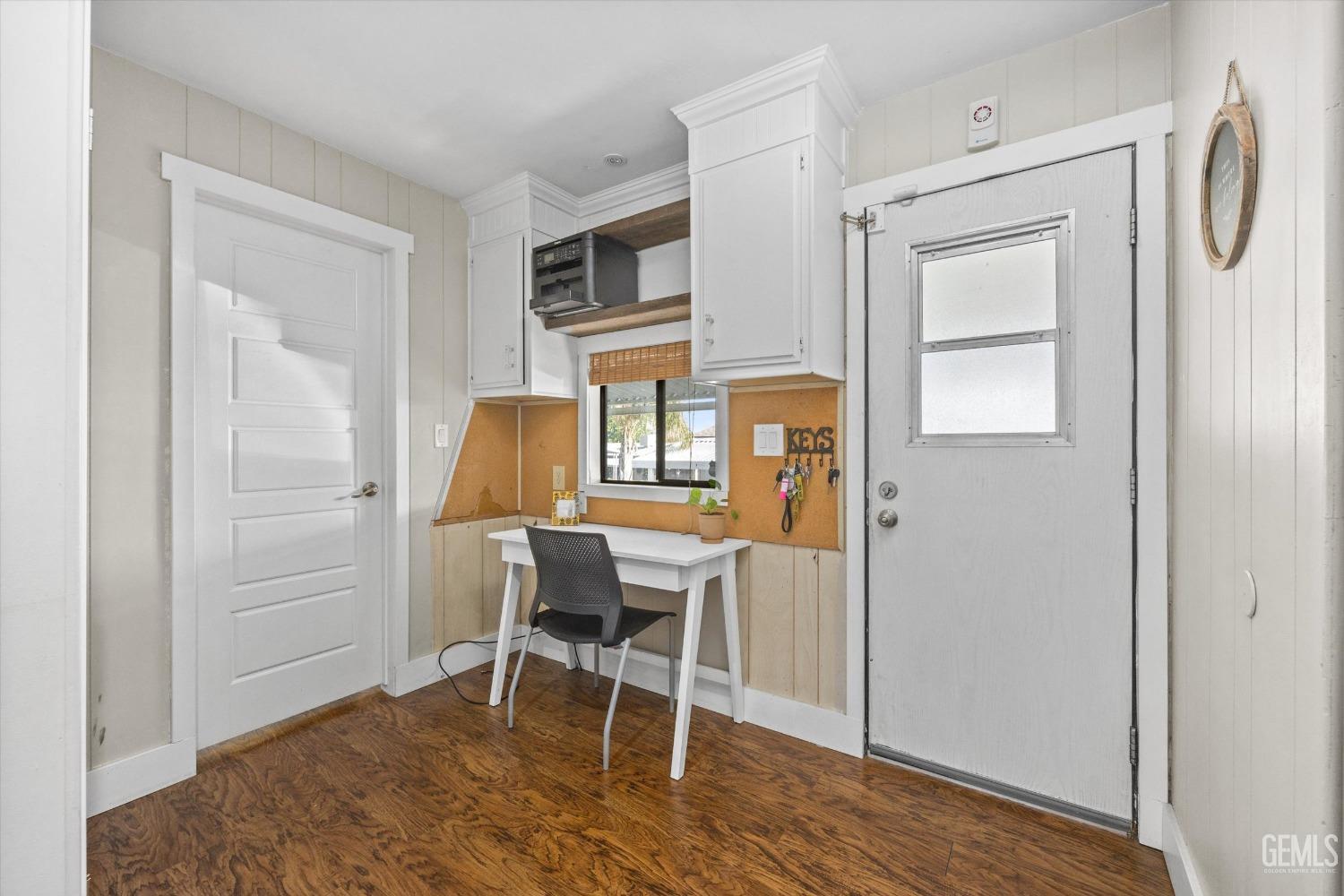 Undisclosed Address Bakersfield, CA 93306 - Photo 29 of 39 a workspace room with wooden floor cabinet and windows