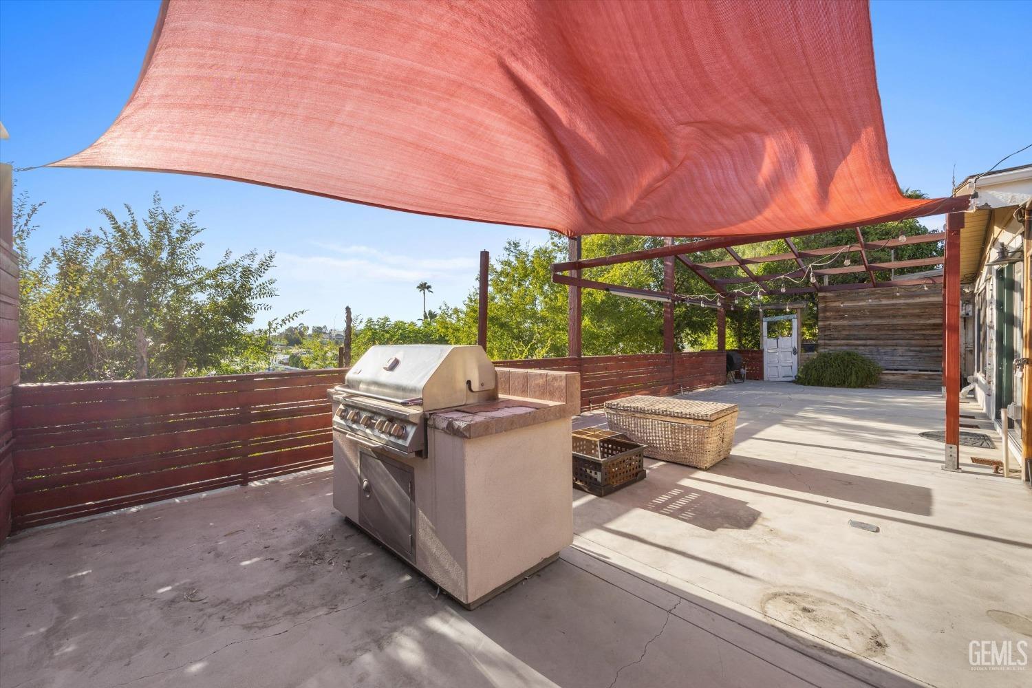 Undisclosed Address Bakersfield, CA 93306 - Photo 33 of 39 a view of a patio with table and chairs under an umbrella