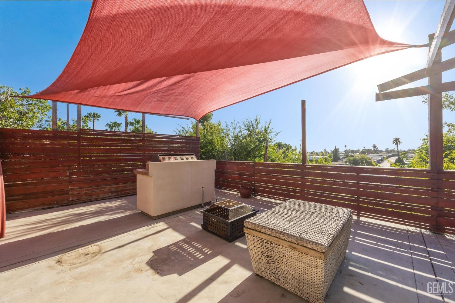 Undisclosed Address Bakersfield, CA 93306 - Photo 37 of 39 a view of a patio with table and chairs under an umbrella