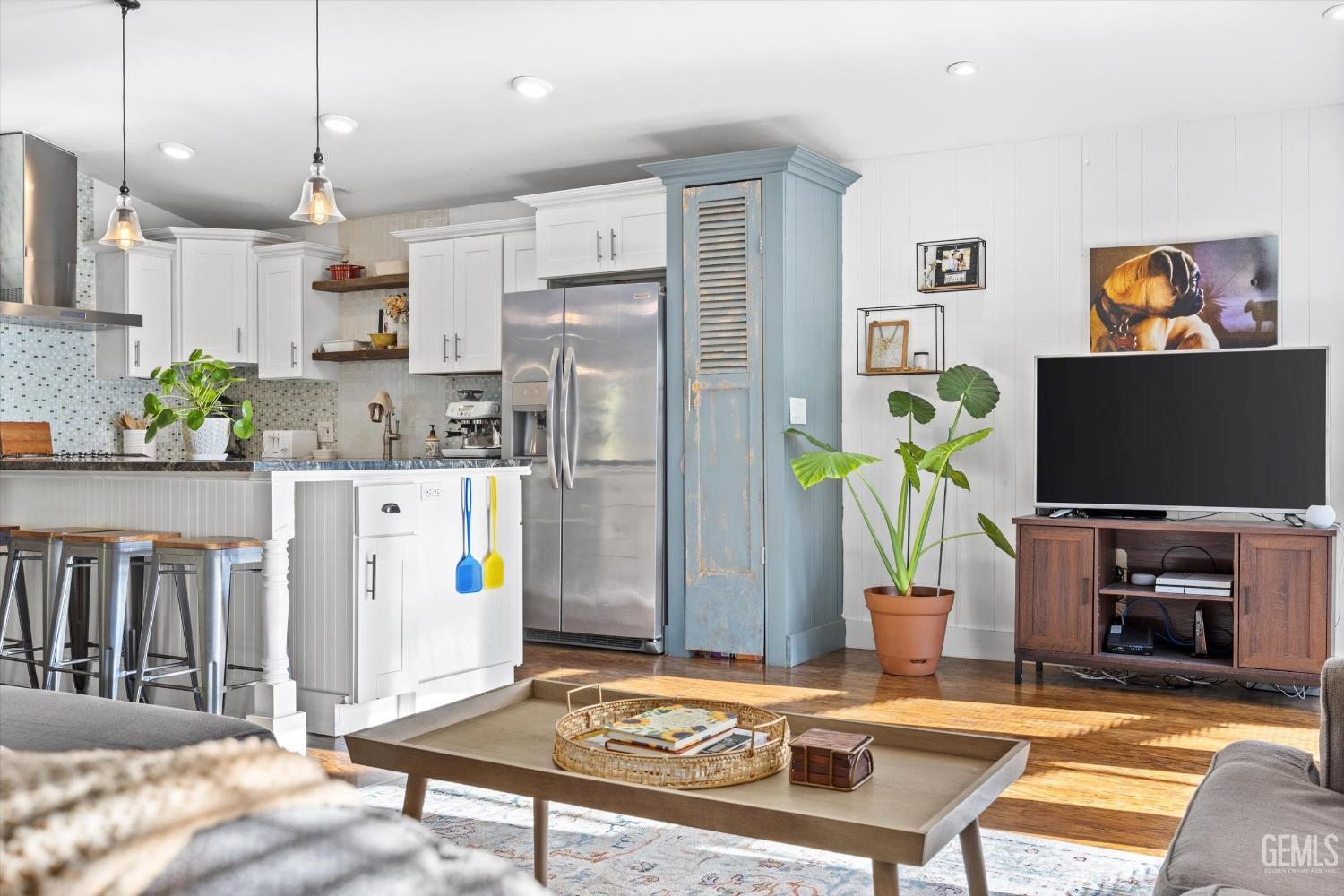Undisclosed Address Bakersfield, CA 93306 - Photo 8 of 39 a living room with furniture a flat screen tv and kitchen view