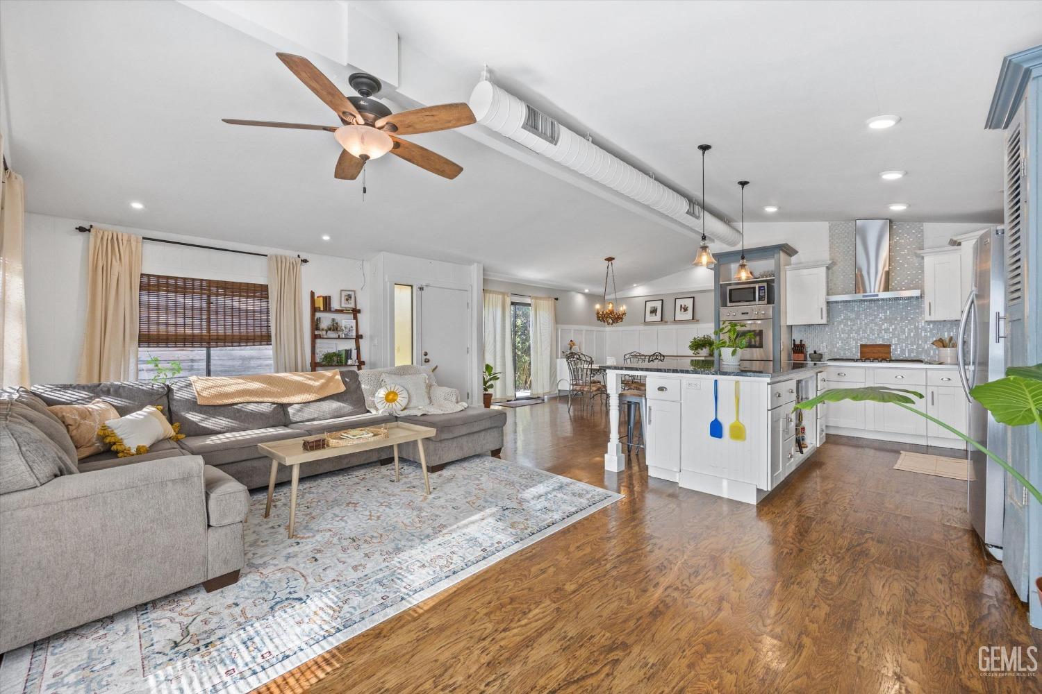 Undisclosed Address Bakersfield, CA 93306 - Photo 10 of 39 a living room with lots of furniture and kitchen view