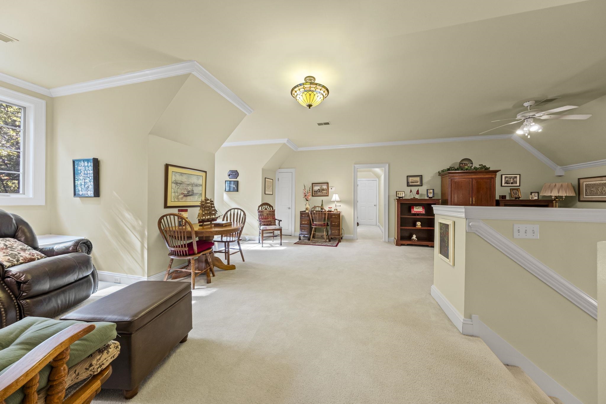 450 Cherry Road Eads, TN 38028 - Photo 7 of 24 Sitting room with ornamental molding, light carpet, an upstairs landing, and ceiling fan