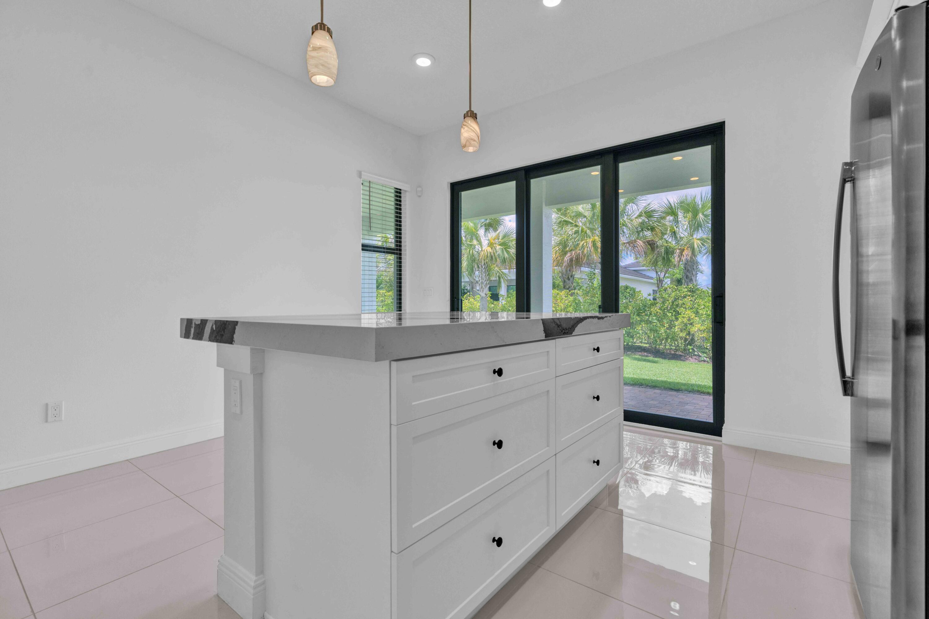 5501 Santa Rosa Lane Westlake, FL 33470 - Photo 11 of 31 a room with a large window and a potted plant