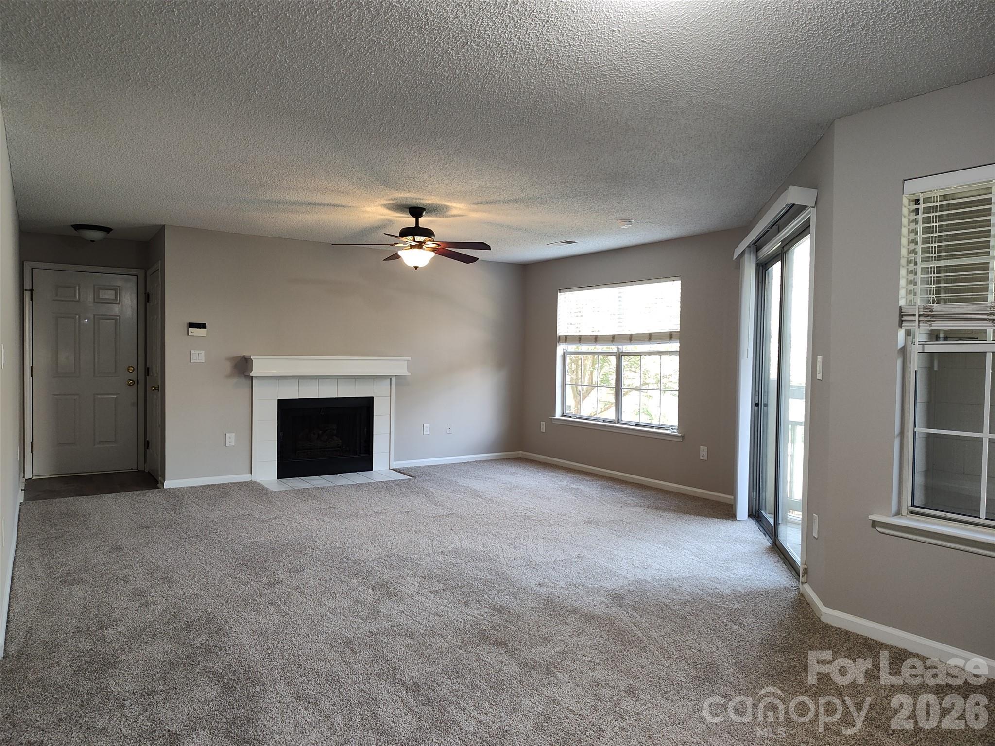 5001 Sharon Road, Unit K Charlotte, NC 28210 - Photo 10 of 24 an empty room with windows and fireplace